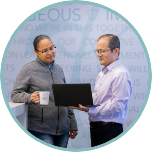 A man and a woman discussing available prothena career opportunities