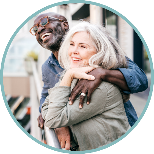 A man and a woman smiling as they think about the possibilities of prothena's clinical trials